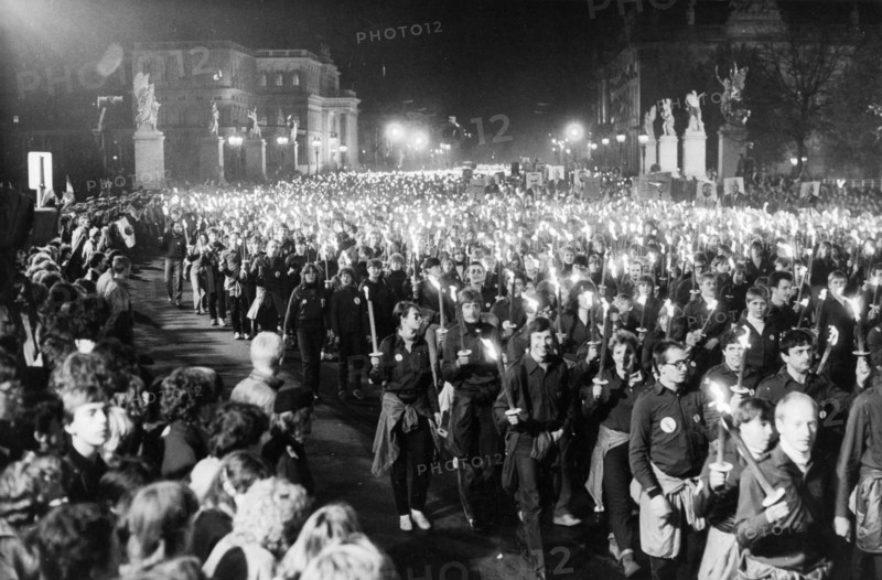 A torchlight procession of free german youth organization members in honor of the 35th anniversary of the gdr on unter der linden avenue in berlin, october 10, 1984.
