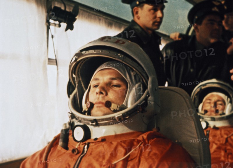 Cosmonaut yuri gagarin on a bus on the way to the launch site of vostok i april 12, 1961, seated behind him is his substitute, gherman titov.
