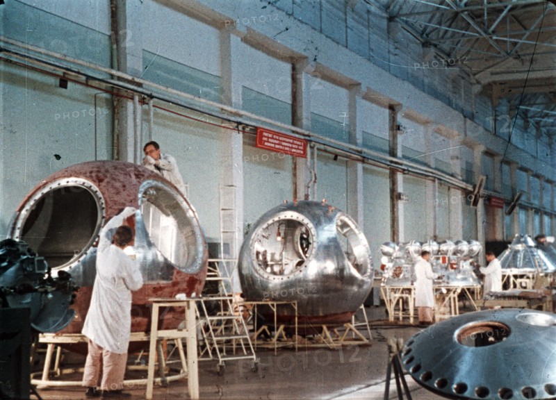 Work being done on the vostok 1 capsule in preparation for gagarin's historic flight, 1961, this is a still from a soviet film about the space program.