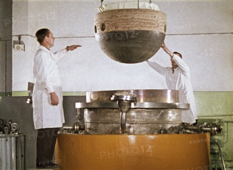 The descent capsule of the soviet space probe venera 5 or 6 being lowered into an installation for testing heat resistance, 1968, this is a still from the film 'the storming of venus', produced by e, kuzis at the tsentrnauchfilm central scientific film studio, released on may 17, 1969.