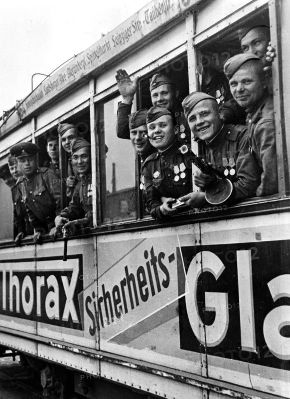 Soviet soldiers riding a berlin tram, 1945, after germany's surrender.