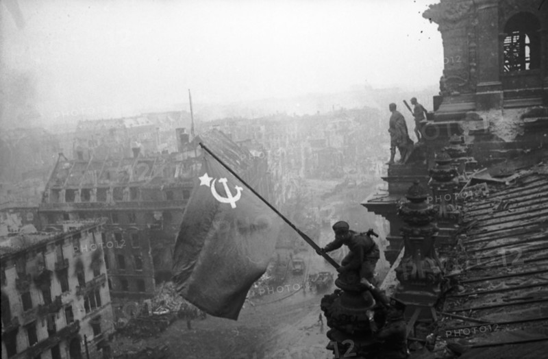 Red army soldiers raising the soviet flag over the reichstag in berlin, germany, april 30, 1945.