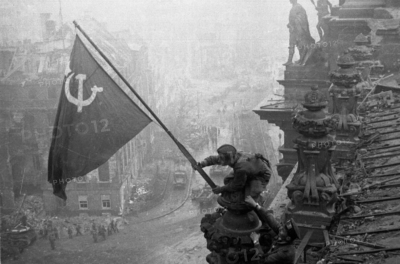 Red army soldiers raising the soviet flag over the reichstag in berlin, germany, april 30, 1945.