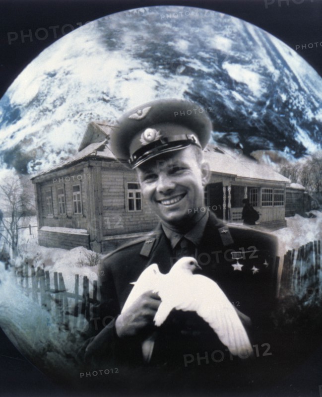 Cosmonaut yuri gagarin holding a white dove.