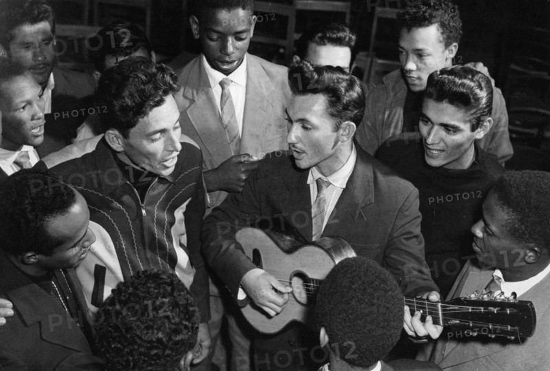 Cuban students, future machine operators, playing guitar and singing songs during their free time, cuba, 1961.