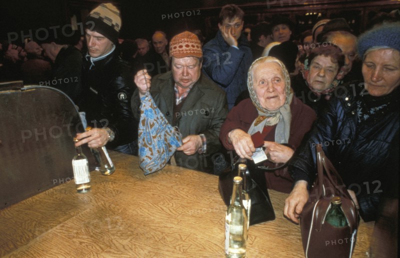 A crowd of people buying vodka in moscow, russia duing times of shortages, march 1991.