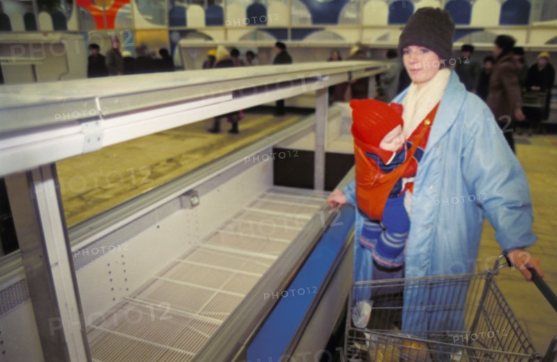 A mother with her child shopping in a moscow supermarket during the times of economic reforms which brought about shortages and rising prices, 1991.