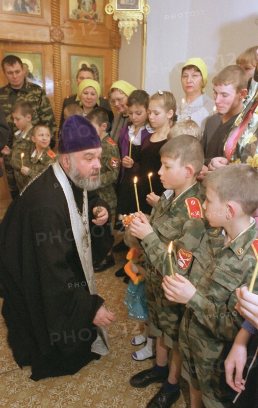 Kemerovo region, russia, january 31, 2002, father nikolai anointing with chrism young cadets (in pic) from orphanage in novokuznetsk (a city in siberia), about 20 inmates from 3 to 17 years old were baptized in home church of the vladimir icon of our lady in the city, their tutors and senior pupils became godparents for the newly converted.