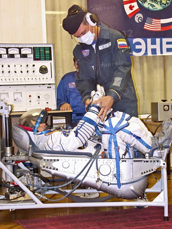 Baikonur, kazakhstan, september 18, 2006, a russian specialist checks the spacesuit of first female space tourist anousheh ansari before the launch of soyuz tma-9 rocket, which spacecraft is to take the 14th iss crew to the international space station.
