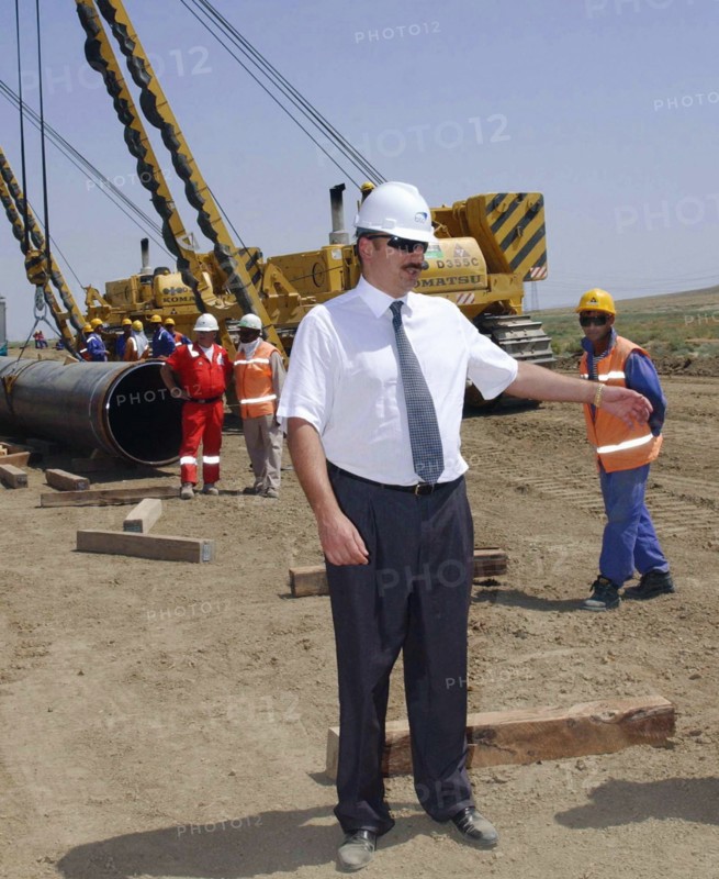Azerbaijan, august 11, 2003, head of azerbaijan government ilkham aliyev (c) pictured visiting the construction site of the baku-ceyhan oil pipe line,on monday.