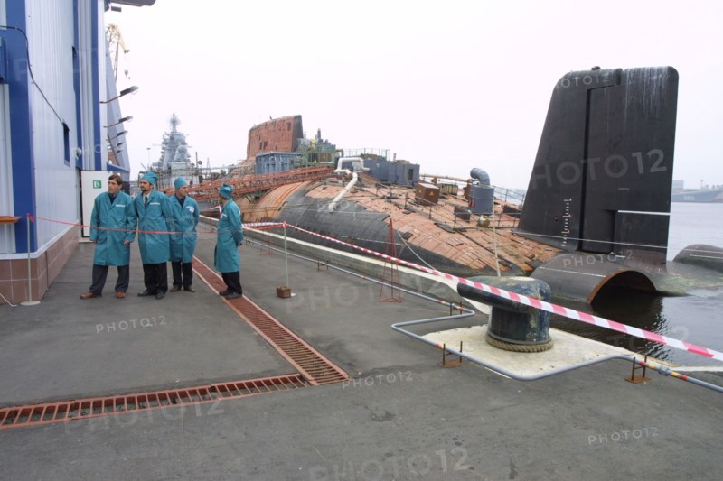 Decommissioned russian 'taifun' (typhoon) strategic nuclear sub moored next to a coastal complex for the discharge of spent nuclear fuel from the reactors of defunct submarines which was inaugurated at the shipbuilding plant zvyozdochka on friday, arkhangelsk region, russia, august 24 2002.