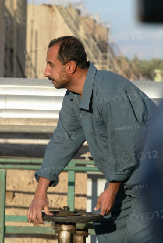 Baghdad, iraq, february 8 2003, worker (in pic) at one of large oil refineries on the outskirts of baghdad.