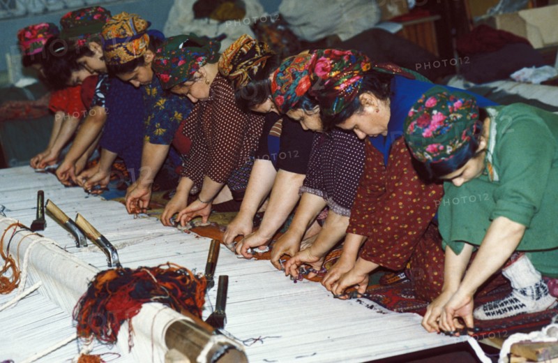 Turkmen women weaving rugs by hand at a factory in ashgabat (ashkabad), turkmenistan.