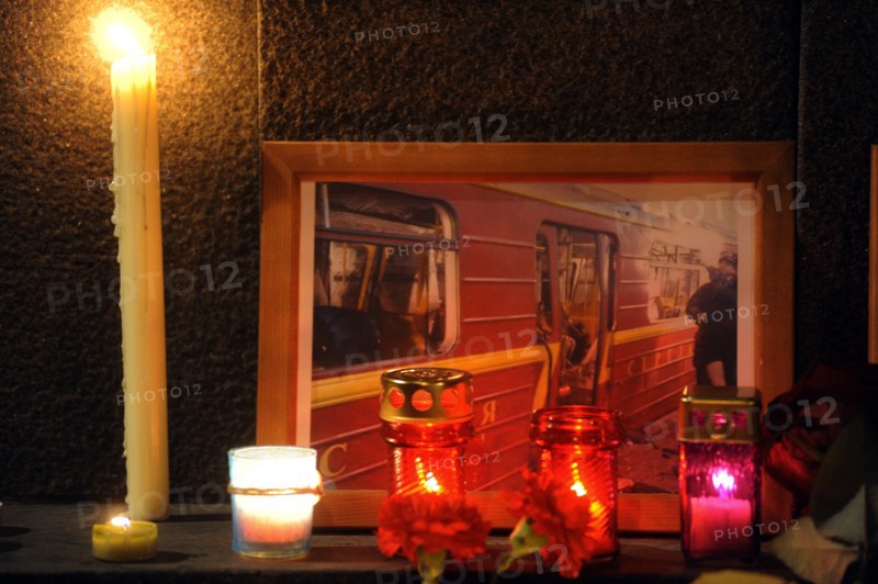 Moscow, russia, march 30, 2010, a photograph of a damaged metro carriage and candles to commemorate victims of the metro bomb explosions, blasts rocked two stations on sokolnicheskaya line of the moscow underground during the rush hour killing 38 and injuring over 60 passengers.