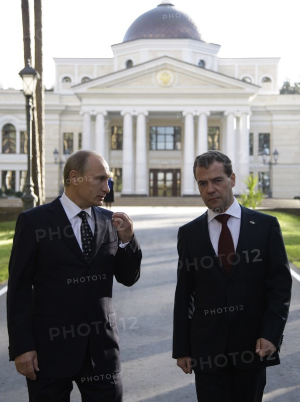 Moscow region, russia, october 1, 2010, president of russia dmitry medvedev (r) and prime minister vladimir putin chat during a walk at gorki residence.