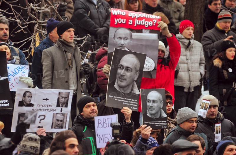 Moscow, russia, december 27, 2010, supporters of mikhail khodorkovsky hold up his portraits during a rally outside the khamovniki district court, the court is expected to issue its ruling on the second case against former yukos boss mikhail khodorkovsky and former menatep bank chief platon lebedev, the two men have been found guilty of stealing more than 200m tonnes of oil from yukos subsidiaries.
