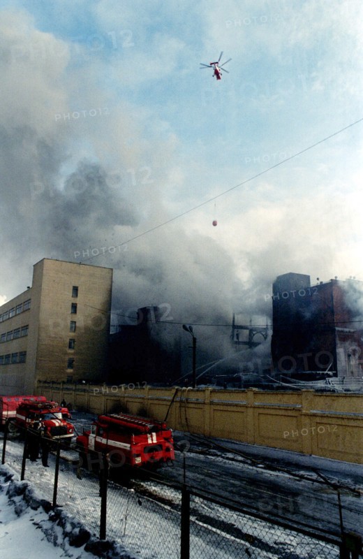 The fire in the building of moscow tire plant that broke out in the store-room of rubber is almost put out, eight water tanks, two hydrolic lifts and 15 air-pumps continue to work on the site,a helicopter continues to deliver water from the moscow river /in pic/,until recently the moscow tyre plant supplied tires for two car factories - zil and azlk, february 26, 1996.