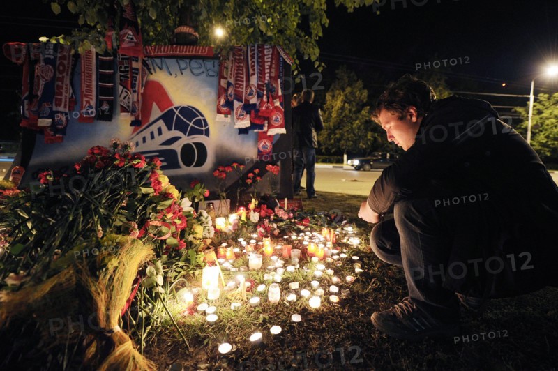 Yaroslavl, russia, september 8, 2011, lokomotiv yaroslavl fans commemorate players of a khl ice hockey team lokomotiv who died in a yak-42 passenger plane crash on september 7 by laying flowers and lighting candles at the arena-2000 stadium.
