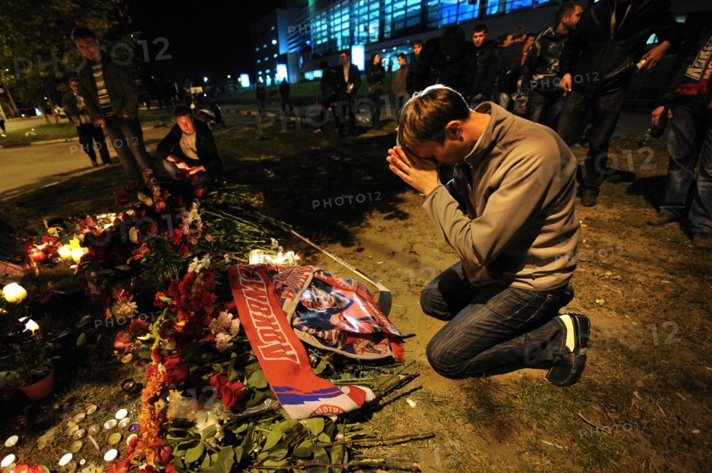 Yaroslavl, russia, september 8, 2011, lokomotiv yaroslavl fans commemorate players of a khl ice hockey team lokomotiv who died in a yak-42 passenger plane crash on september 7 by laying flowers and lighting candles at the arena-2000 stadium.