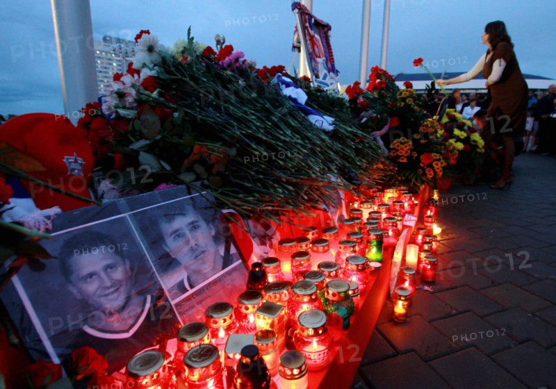 Minsk, belarus, september 9, 2011, people lay flowers and light candles outside minsk-arena stadium to commemorate hc lokomotiv yaroslavl team players who died in a plane crash on september 7, a khl game lokomotiv vs, dinamo minsk was due to take place here on september 8.