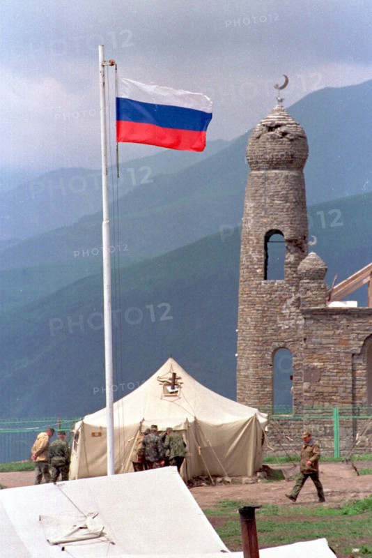 This minaret near the settlement of tuskhoroi in the argun gorge was a part of the ancestral estate of yandarbiyev, one of the leaders of chechen rebels, now the military tents are put there to accomodate temporarily border guards of the itum-kalinsky detachment of the federal border guard service, chechnya, russia, june 28, 2000.