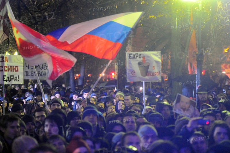 Moscow, russia, december 5, 2011, demonstrators wave flags during an opposition protest in central moscow against alleged vote-rigging in the december 4 parliamentary election.
