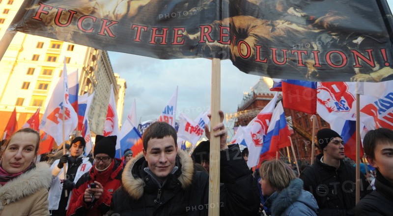 Moscow, russia, december 12, 2011, young demonstrators carry a placard reading fuck the revolution! during a rally staged by pro-kremlin youth groups in central moscow, the event took place two days after a mass protest against alleged vote rigging in the 4 december parliamentary election.