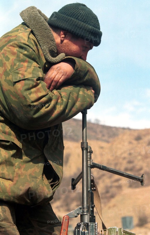 Russian serviceman pictured having a rest after a hard 4-day march his paratroop regiment made from the dzheirakh gorge in ingush republic to the argun gorge in chechnya along a new road to the mountain chechen village of itum-kale on the border with georgia built by military engineers in the rocky terrain in a short time, chechnya, russia, february 29, 2000.