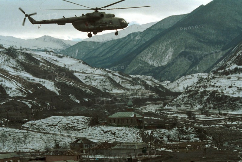 A russian helicopter over the chechen settlement of itum-kale (within 26 km from the russian-geargian frontier) in the argun gorge where the main hq of the russian border-guards detachment is deployed to provide control and protection of this sector of the state border , chechnya, russia, march 2, 2000.