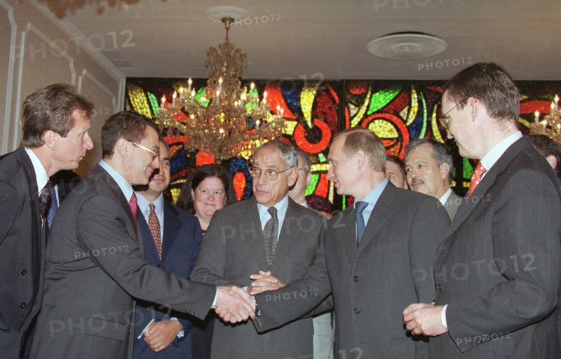 New york, usa, september 9, 2000, russian president vladimir putin shaking hands with chief of the tyumen oil company, or tnk, semyon kukes, at the signing of an accord by the tnk and the u,s, export-import bank, on friday, the accord was signed at the russian mission in the united nations, putin could attended the ceremony as he was in new york city on the occasion of the u,n, millennium summit.