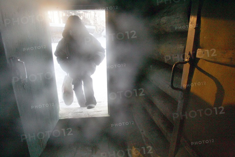 A man entering the predbannik (dressing room) of the banya (russian steam bath) in elnat (yelnat) village in the ivanovo region of russia, 2006.