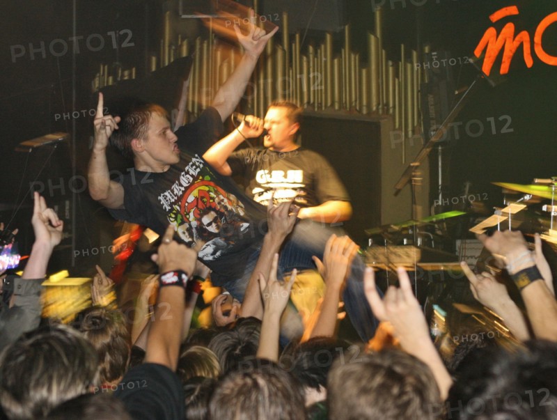 Youth raise their hands as they listen to music at 'tochka' club, the venue of the 'punks in city x' festival, august 26, 2006.