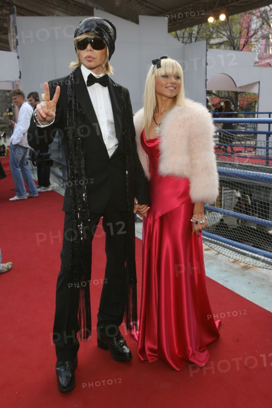 Stylist sergei zverev (l) and his companion pose for a photograph outside the pushkinsky cinema in moscow, the venue of the 2006 mtv russia film awards.