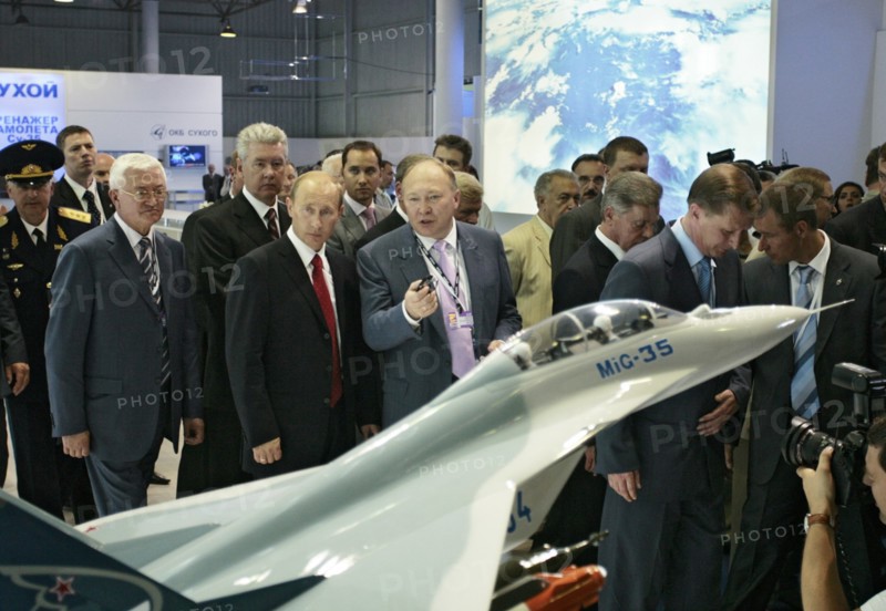 Russian president vladimir putin, head of the united aircraft building corporation, alexei fedorov, l-r, foreground, view a model of mikoyan mig-35 fighter at the 8th international aviation & space salon maks 2007 in the town of zhukovsky, moscow region of russia, august 17, 2007, pictured second from left, background, is putin's chief of staff sergei sobyanin; pictured second from right, background, is russia's first deputy pm sergei ivanov.