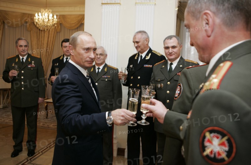 President of russia vladimir putin (foreground l) holds up a glass for a toast during a ceremony of passing the awards, posthumously conferred on the soviet spy george koval, to the museum of russia's main intelligence directorate (gru), at novo-ogaryovo residence, moscow, russia, november 2, 2007.