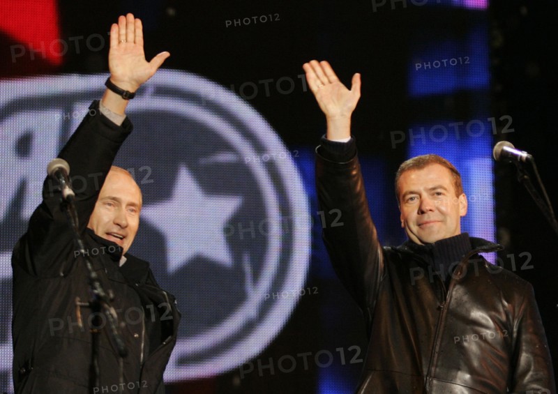 Moscow, russia, march 2, 2008, outgoing president vladimir putin (l) and first deputy prime minister dmitry medvedev wave to the audience during a concert in vasilyevsky spusk off red square, marking the outcome of the 2008 presidential election.