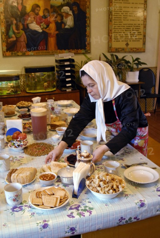 A nun lays the table for meagre dinner in a frater of the nativity of the holy virgin cathedral in chernogorsk during the lent, krasnoyarsk territory, russia, march 20, 2008.