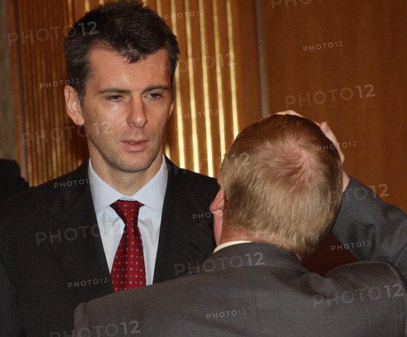 Moscow, russia, october 16, chairman of the board of polyus gold company, onexim group's owner mikhail prokhorov (background) attends a meeting of the organising committee to prepare for the nanotechnology international forum.