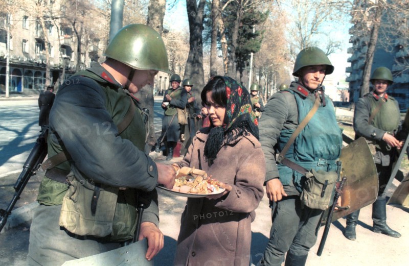 A woman offers a treat to soldiers in dushanbe, a state of emergency was declared in dushanbe after a violent unauthorized rally, policemen and servicemen were deployed to keep order, tajikistan, february 1990.