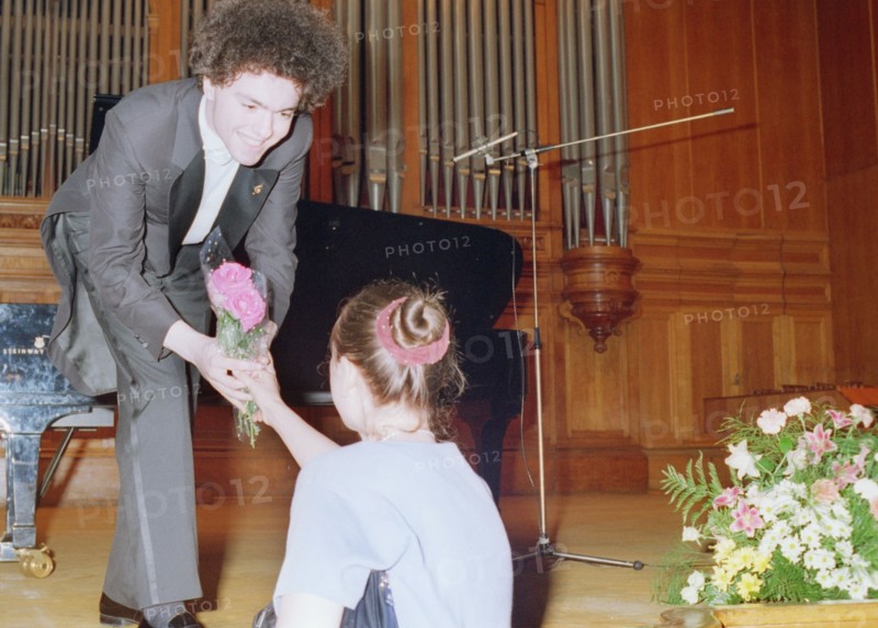 Russian pianist yevgeny kisin accepts a flower from one of his the admirers after an 1997 piano recital.