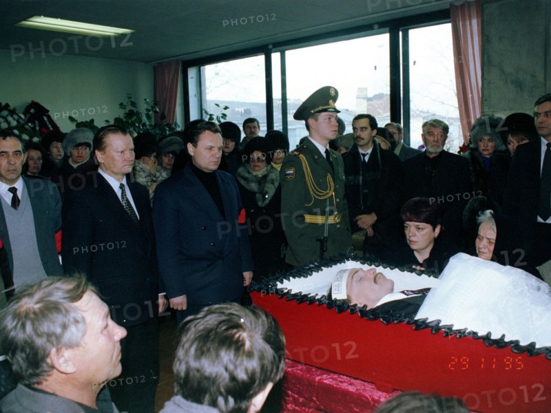 Chairman of state duma ivan rybkin standing center behind coffin at funeral in chita of deputy to the state duma sergey markidonov, killed by hired gunmen on november 26 in the city of petrovsk-zaballkalsky, russia, 1995.