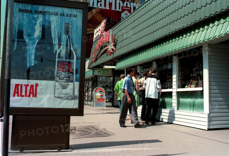 Moscow, russia, 2000, a poster (left) advertising a vodka distilled in the altai territory, and (right) a kiosk selling light alcoholic drinks and beer.