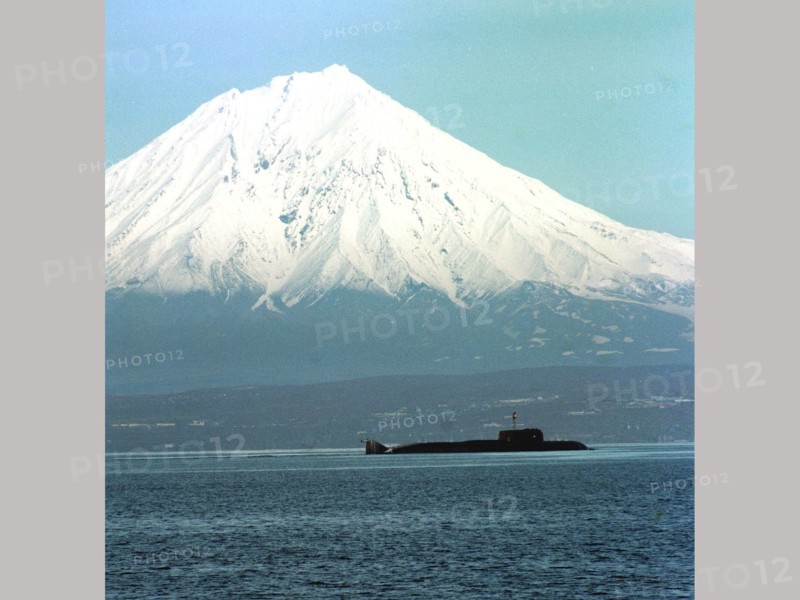 A pacific fleet's nuclear submarine of the granit class shown in the avachinsky harbour (russia's far east), the koryaksky volcano is in the background, kamchatka,russia,may 1, 1999.