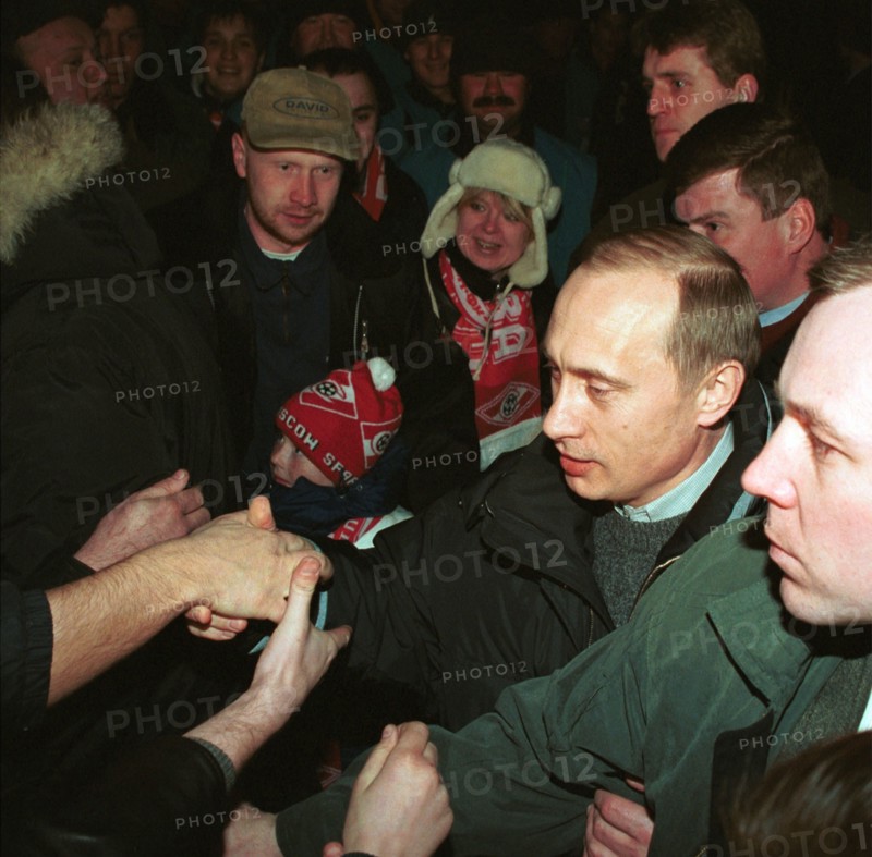 Acting president and prime minister vladimir putin (2nd from right) being greeted by football fans at moscow's luzhniki stadium on saturday when he came to watch a match between spartak moscow and alania vladikavkaz, moscow,russia, march 25 2000.