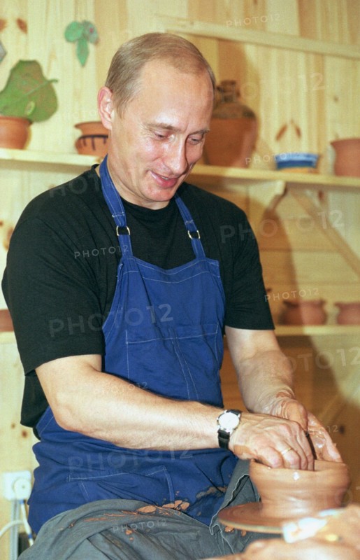 Karelia, russia, august 21 2001, president vladimir putin tries his hand at pottery while visiting the ethnographic village of verkhniye mondrogi on his way to the kizhi island,    21,08,2001 .