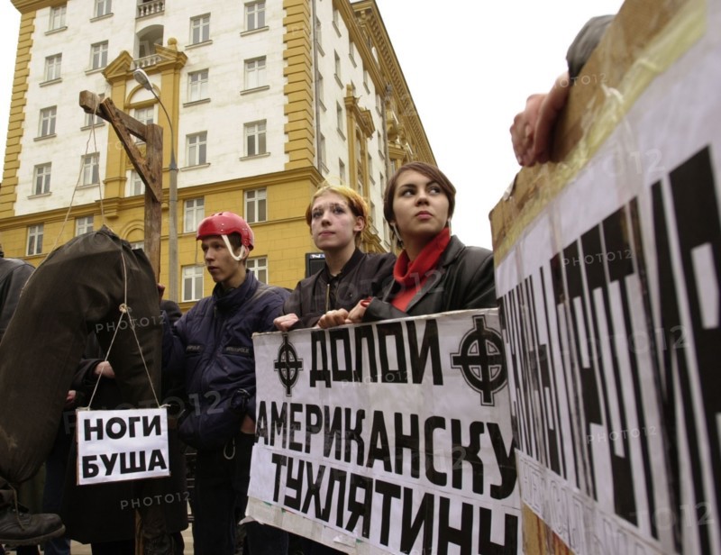 Moscow, russia, march 22 2002: participants of a rally in front of the american embassy protesting import of chicken leg quarters from the u,s,a, about a dozen youngsters took part in the rally, the poster reads: 'away with american rotten stuff!' .