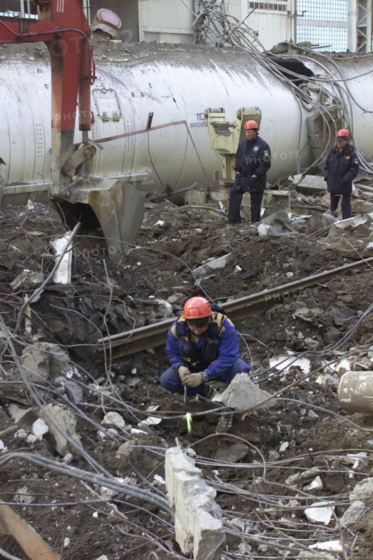 Baikonur, kazakhstan, may 14 2002: workers clearing the fragments of 'energia' rocket carrier and first russian space shuttle 'buran' from debris of the destroyed roof of the assembly and test block where it was stored before the accident , rescuers found seven victims of the tragedy.