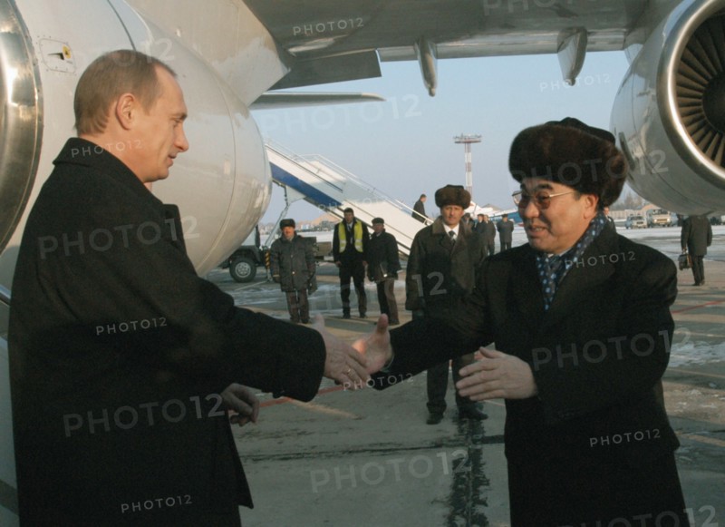 President of russia vladimir putin (left) being met by president of kyrgyzstan askar akayev (right) at bishkek airport, as putin arrived to kyrgyztan for a visit on thursday, dec, 5, 2002.