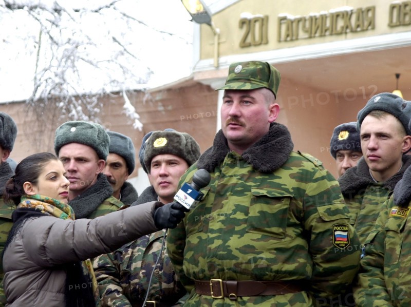 Oleg kozlov, a warrant officer of the 201st russian motorized division stationed in tajikistan pictured asking president vladimir putin a question during his live dialogue with russian people broadcast by tv, dec, 19, 2002.