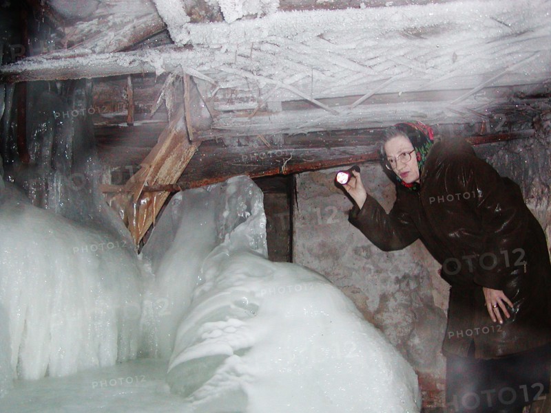 Nizhni novgorod, russia, january 14 2003: valentina kotyashova pictured examining the basement of her house after heavy frosts that paralyzed the water and heat supply pipes, people in 176 old houses in the centre of the city remained without heat and water supply in nizhni novgorod due to severe frosts, (photo itar-tass/ roman yarovitsyn) .
